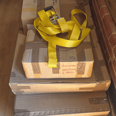 Cardboard boxes containing flat packed theatre seating and components ready to be assembled at Hanger Farm.